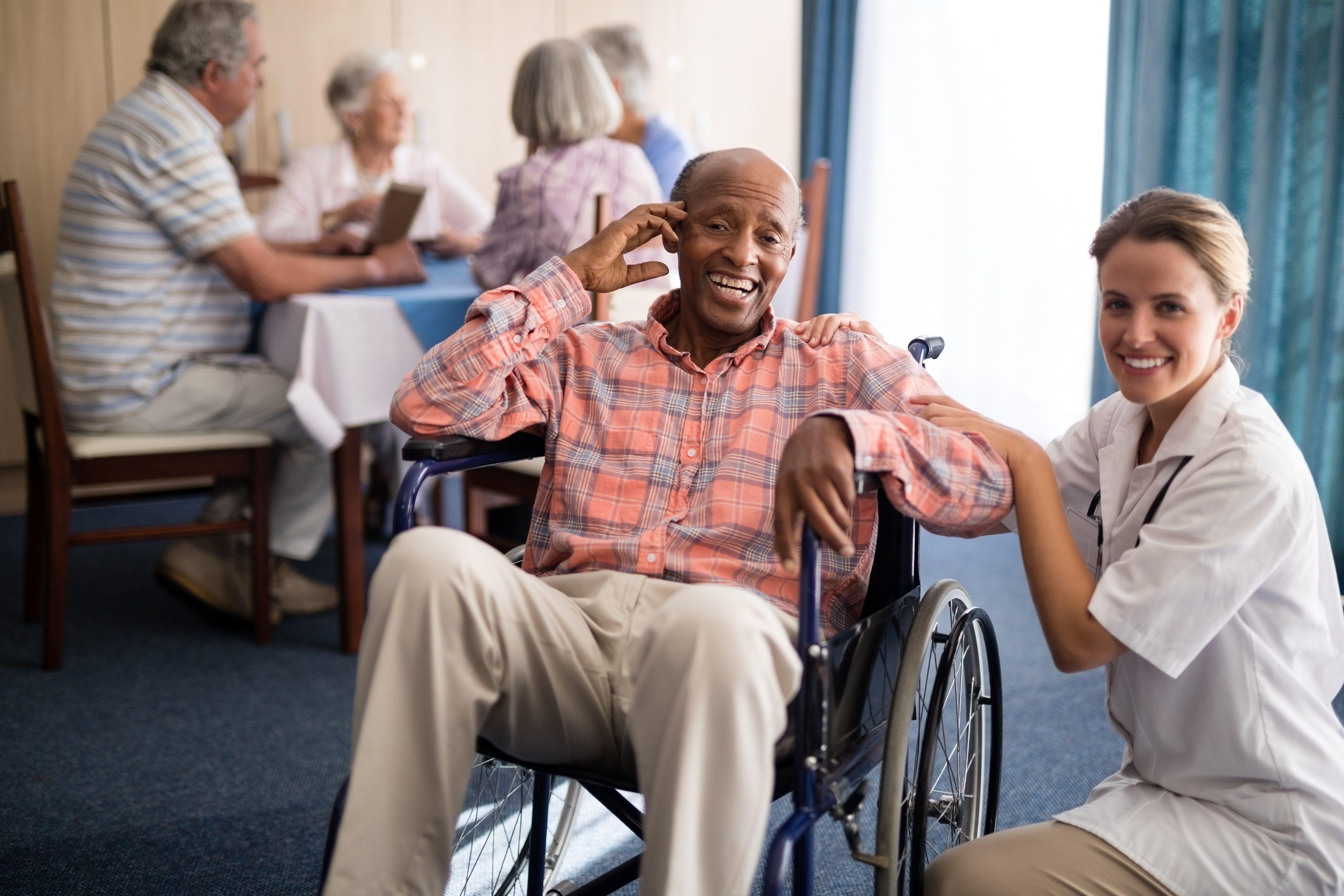 Portrait of cheerful disabled senior man sitting on wheelchair